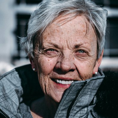 Frau mit grauen Haaren und Jacke